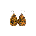 Pair of golden-tan PU leather teardrop earrings with black and brown leopard spots and silver-tone hook ear wires on white