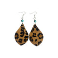 Pair of tan leaf-shaped PU leather earrings with black leopard spots, round turquoise-coloured beads and silver-tone hook ear wires on white
