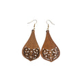 Pair of brown wooden pointed teardrop earrings with solid upper sections, floral cut-outs across the bottoms and gold-tone hook ear wires on white