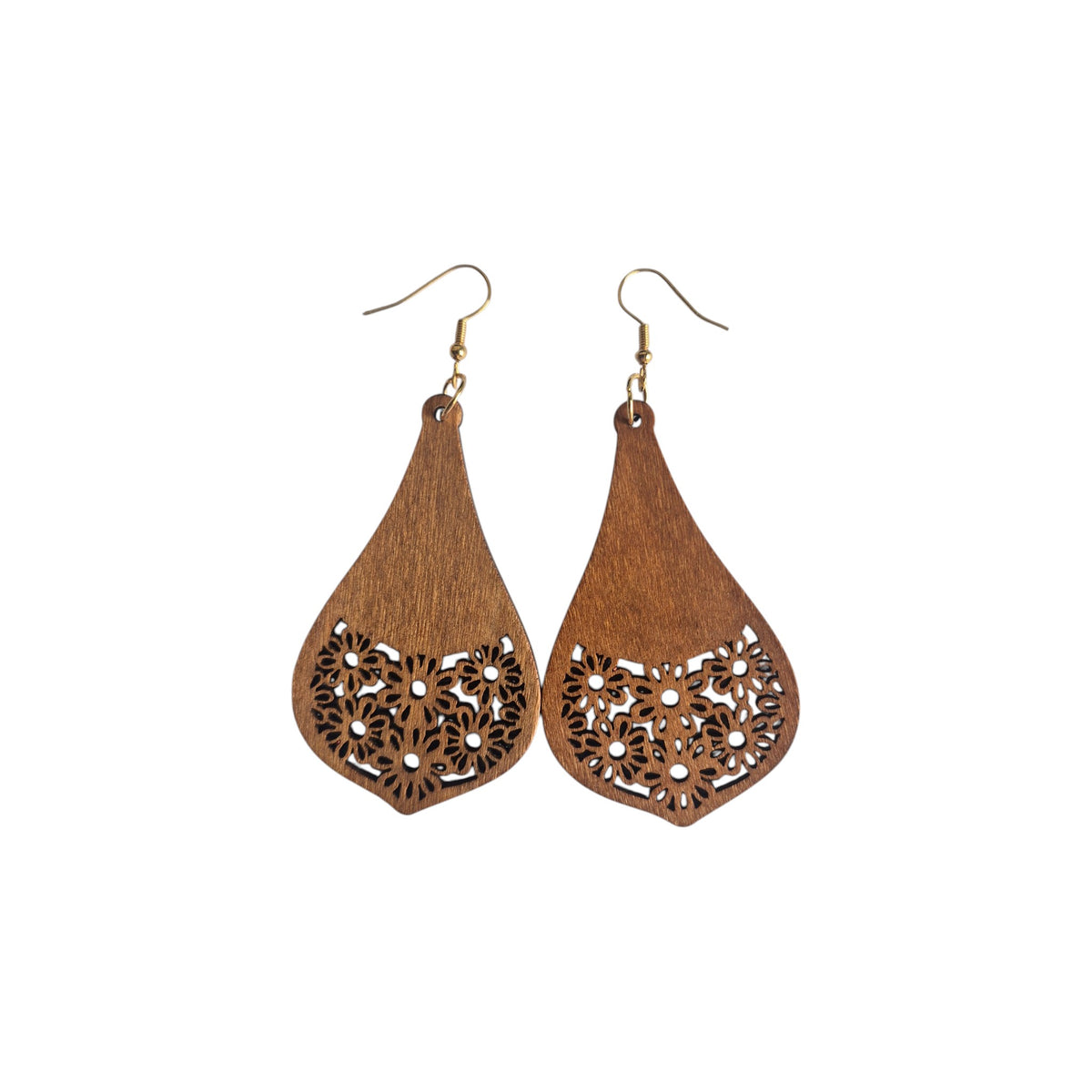 Pair of brown wooden pointed teardrop earrings with solid upper sections, floral cut-outs across the bottoms and gold-tone hook ear wires on white
