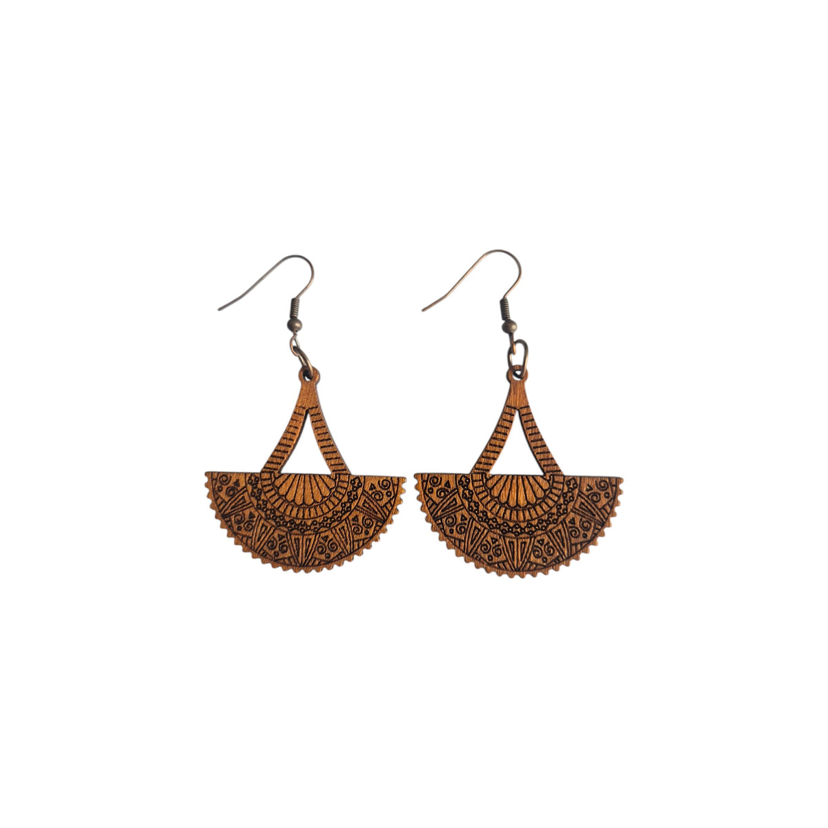 Pair of brown fan-shaped wooden earrings with ornate dark patterns, scalloped lower edges, triangular openings and bronze-tone hook ear wires on white