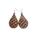 Pair of brown wooden teardrop earrings with rows of curved scallop-pattern cut-outs, small pointed openings and gold-tone hook ear wires on white