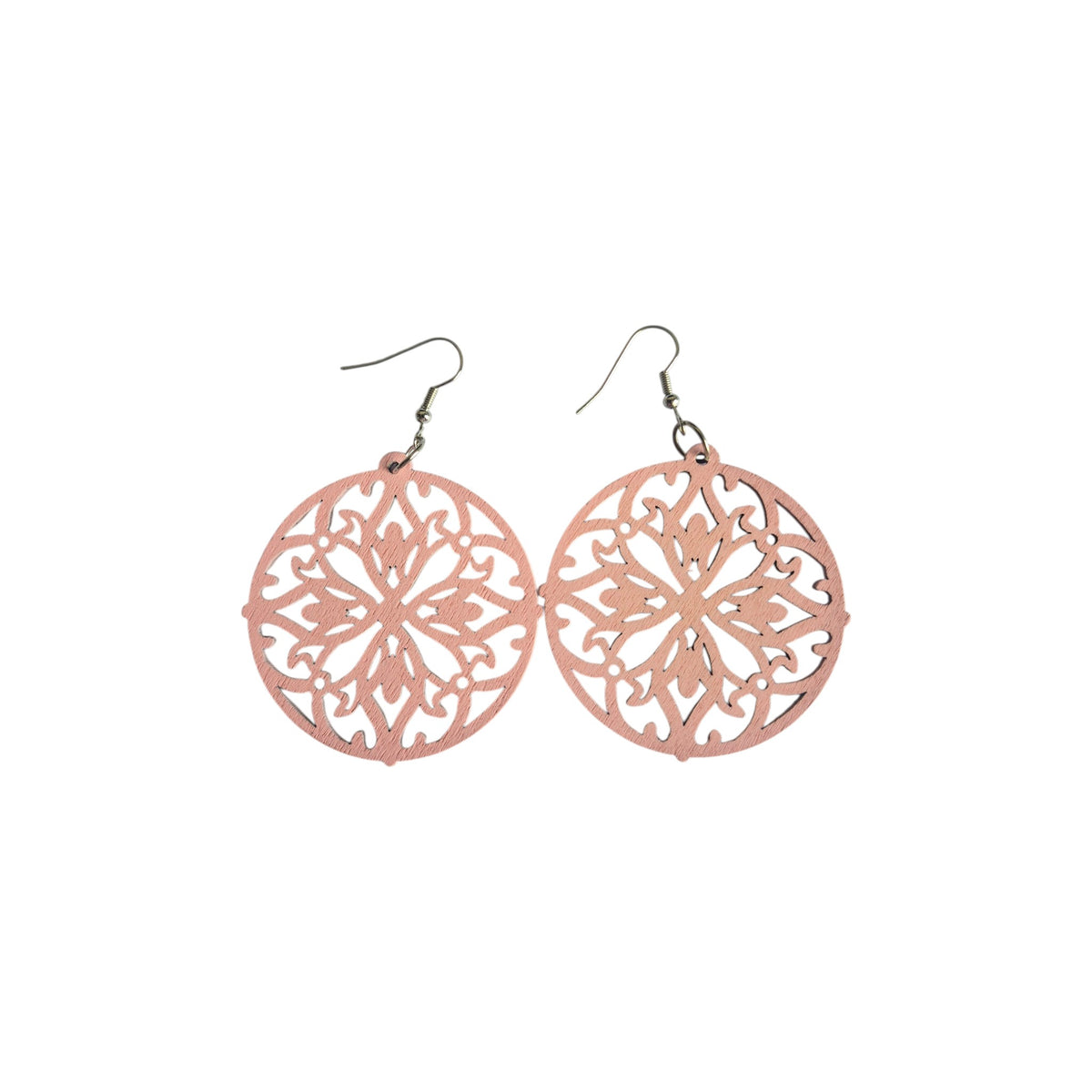 Pair of pink round wooden earrings with symmetrical floral openwork and curling decorative cut-outs, with silver-tone hook ear wires on white