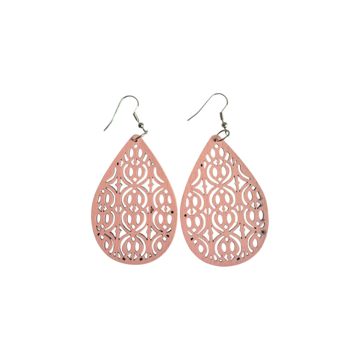 Pair of pink wooden teardrop earrings with symmetrical scroll-pattern cut-outs and silver-tone hook ear wires on a white background