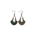 Pair of bronze-tone fan-shaped metal drop earrings with elongated open centres, green accents and hook ear wires on white