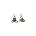 Pair of bronze-tone Celtic knot metal drop earrings with triangular interwoven loops, green central accents and hook ear wires on white