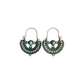 Pair of bronze-tone half-moon metal hoop earrings with ornate openwork, green accents, round green centrepieces and arched ear wires on white