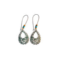 Pair of bronze-tone teardrop filigree metal earrings with green accents, turquoise-coloured and orange beads, and long loop-style ear wires on white