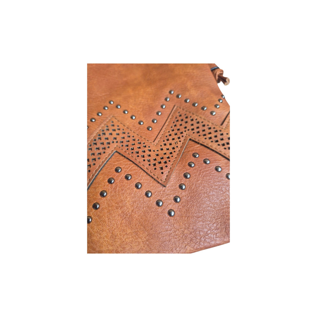 Loren Boyd Chevron Stud laser cut crossbody handbag with geometric design and adjustable strap, showcasing craftsmanship. nz