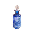 Blue glass bottle with white geometric diamond pattern and crystal stopper