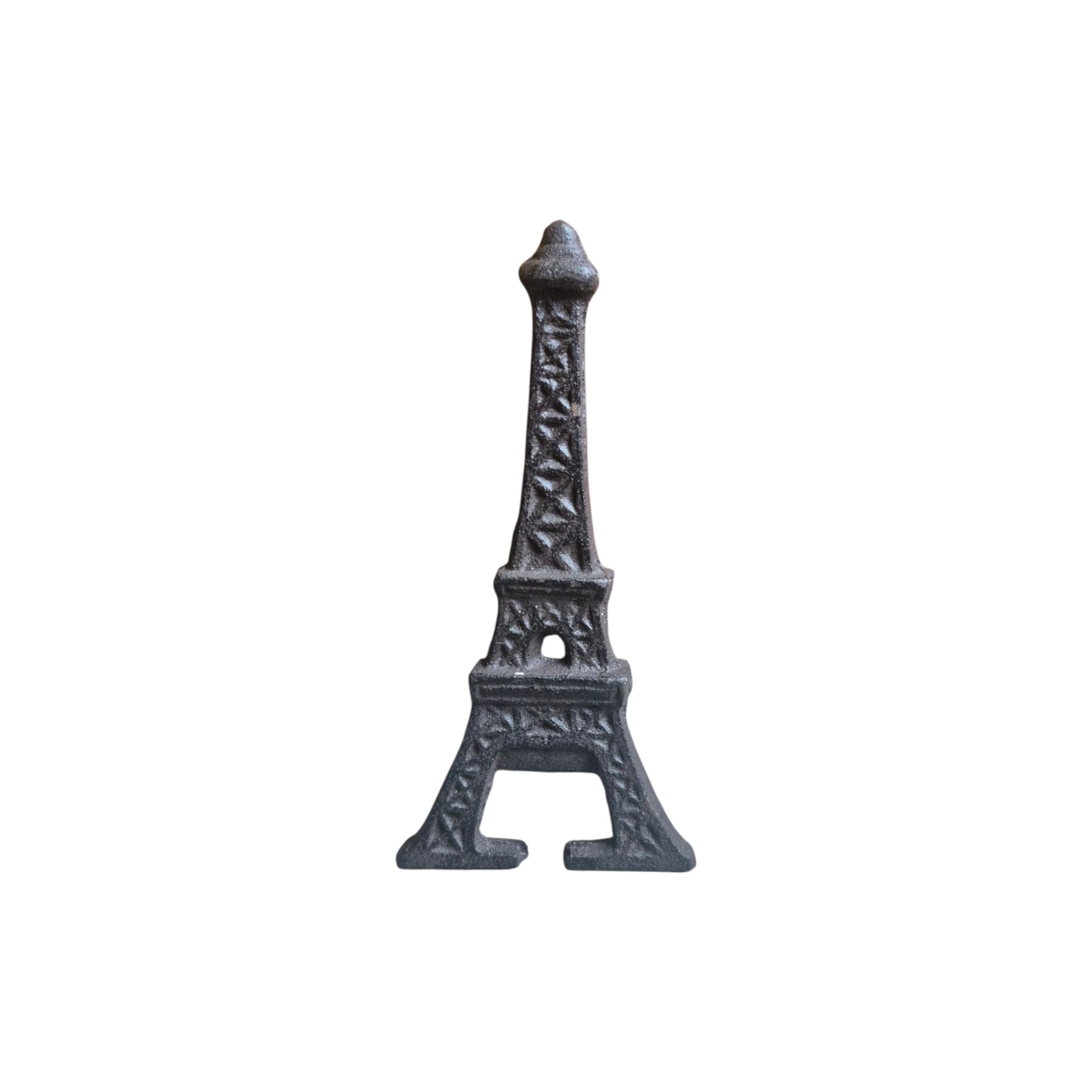 Loren Boyd Eiffel Tower cast iron bottle opener mounted on wall for opening bottles with decorative Eiffel Tower design.